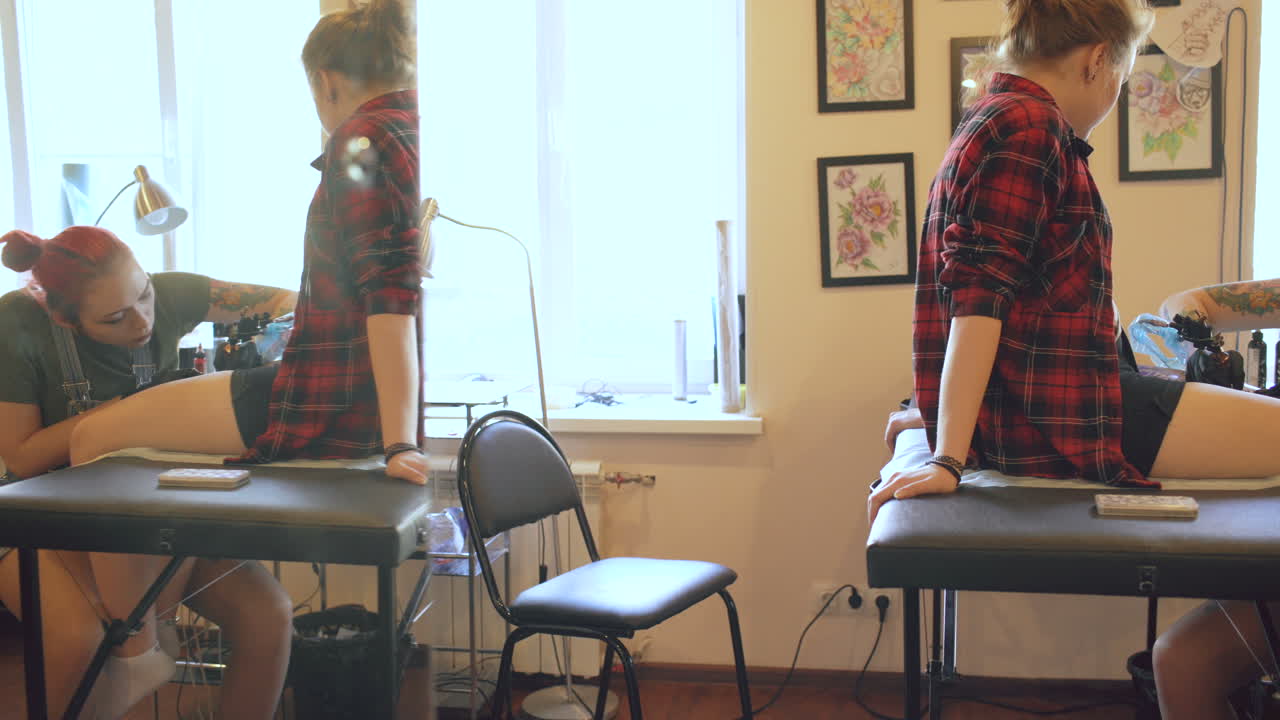 Tattoo Artist Working on a Client