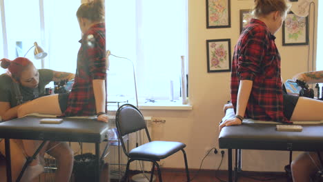 tattoo artist working on a client