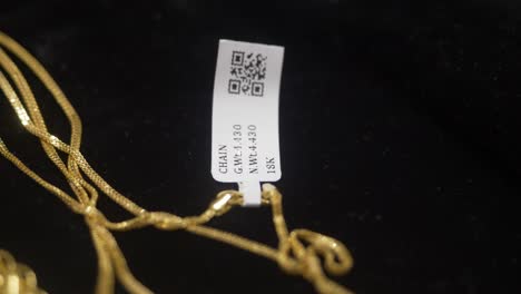 hallmarked 18k gold with barcode tag, closeup