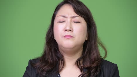 mature beautiful asian businesswoman looking bored