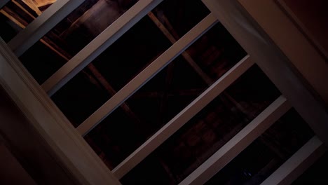 rotating shot of a glass ceiling looking into the attic of a chateau