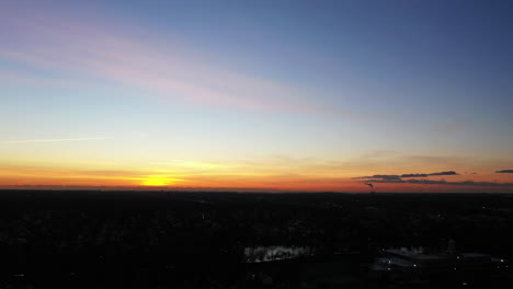 an aerial shot of a suburban neighborhood during a golden sunrise