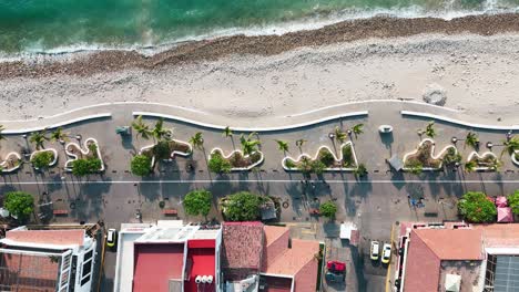 drone reveals puerto vallarta mexico's boardwalk in top view as tourists enjoy walking along it