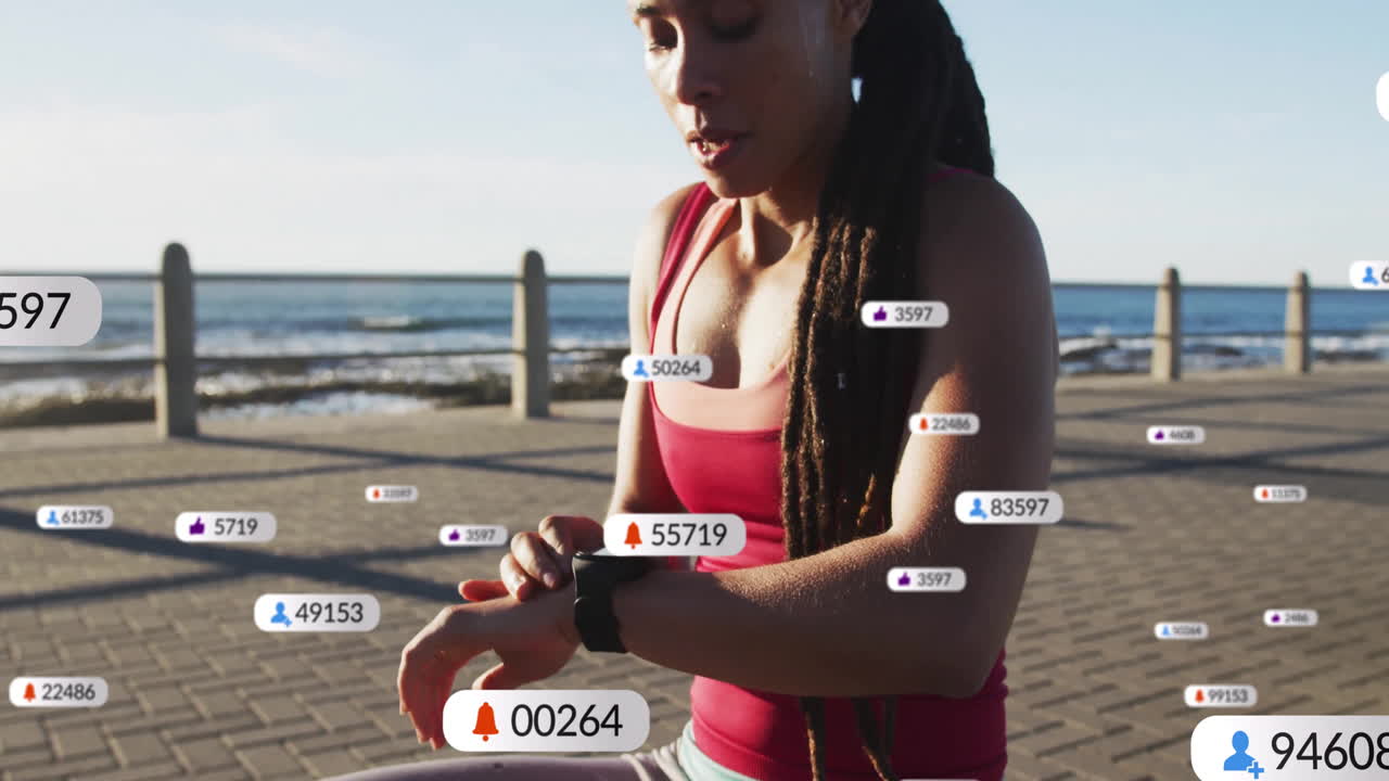 Jogging by beach, woman checking smartwatch with social media animation notifications