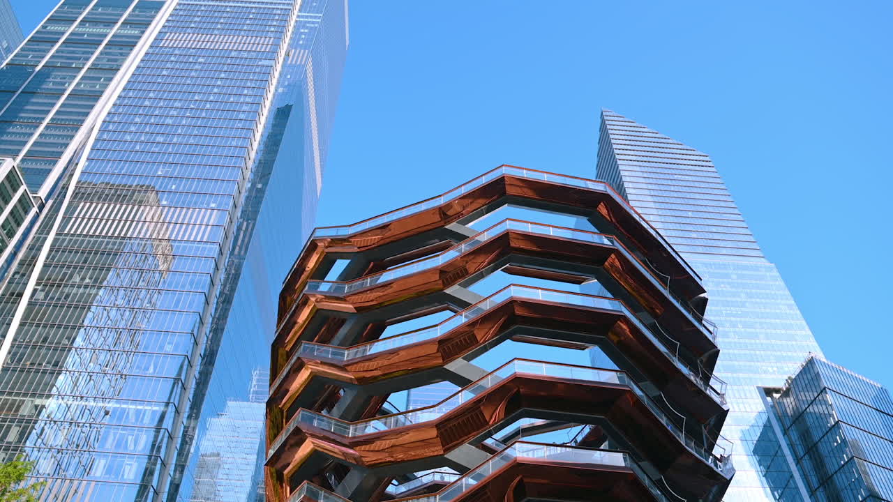 New York, USA, 4 August 2025: The Vessel at Hudson Yards surrounded by modern skyscrapers in New York City. The Vessel structure at Hudson Yards in New York City