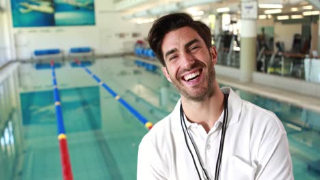 Smiling-trainer-posing-by-the-pool