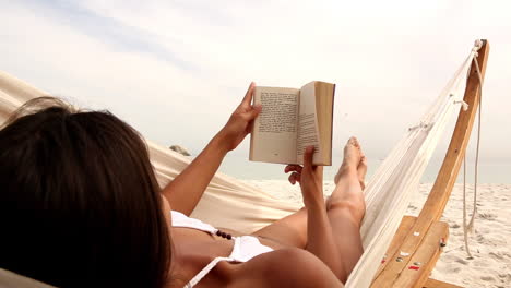 woman relaxing on her hammock on the beach