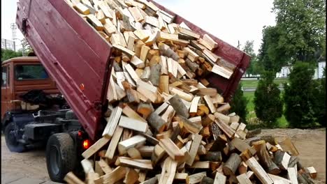 pouring chopped firewood from a dump trailer