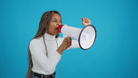 determined woman shouting into megaphone