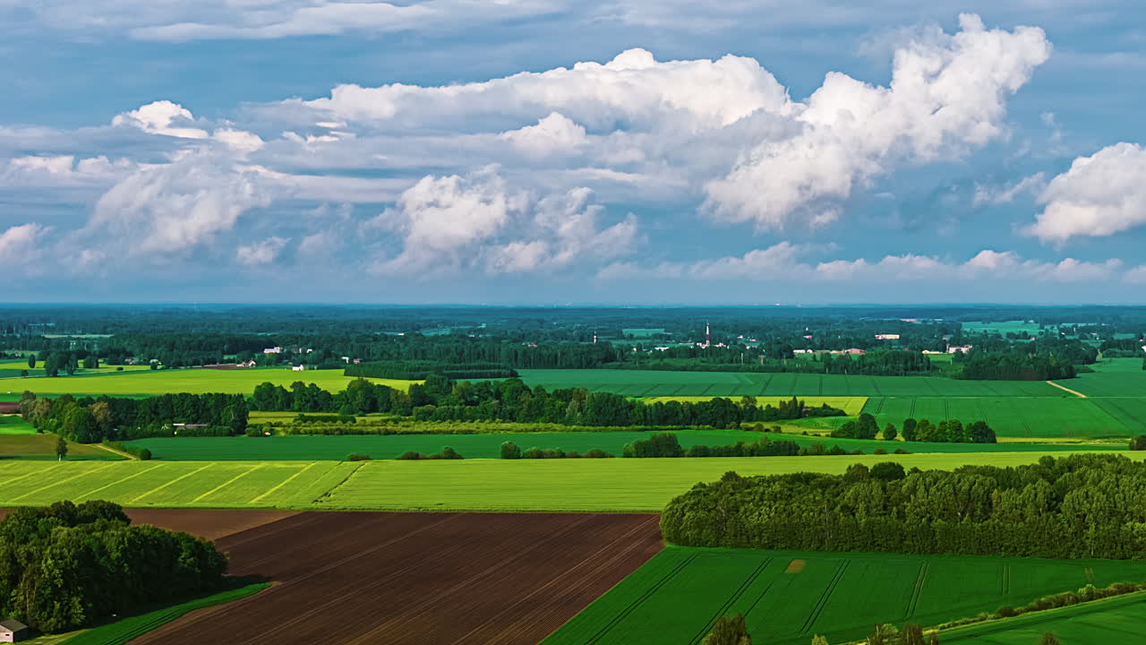 Greenery Cultivated Farmland Against Moving Cloudscape. Timelapse