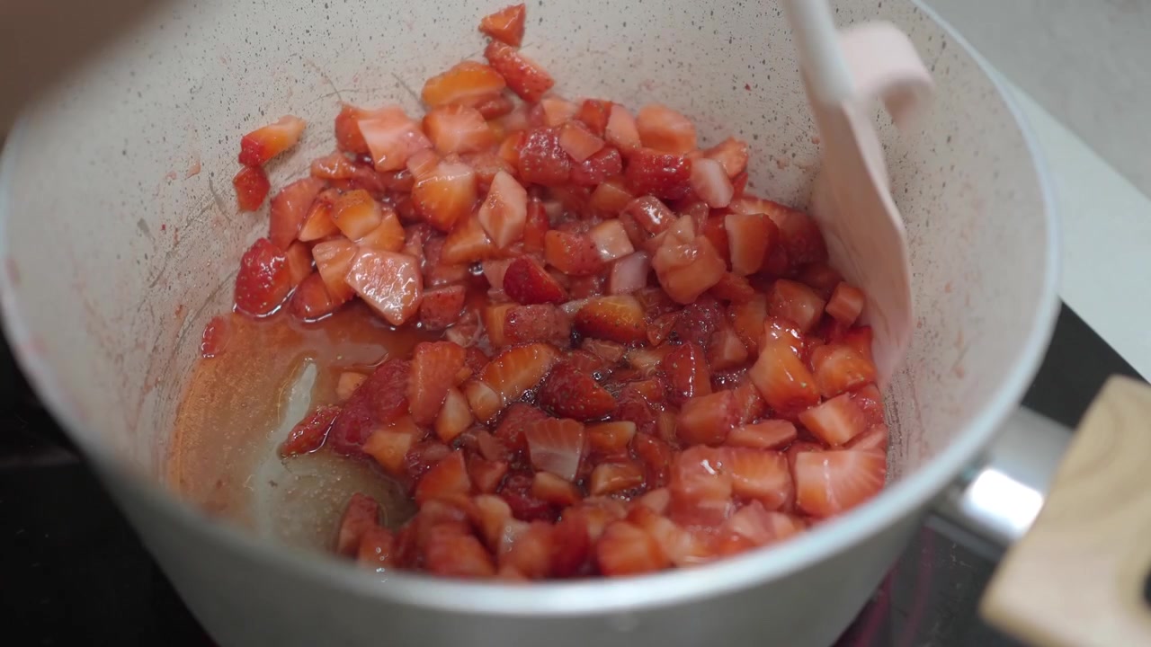 Stirring Diced Strawberries in a Pot for Jam or Sauce