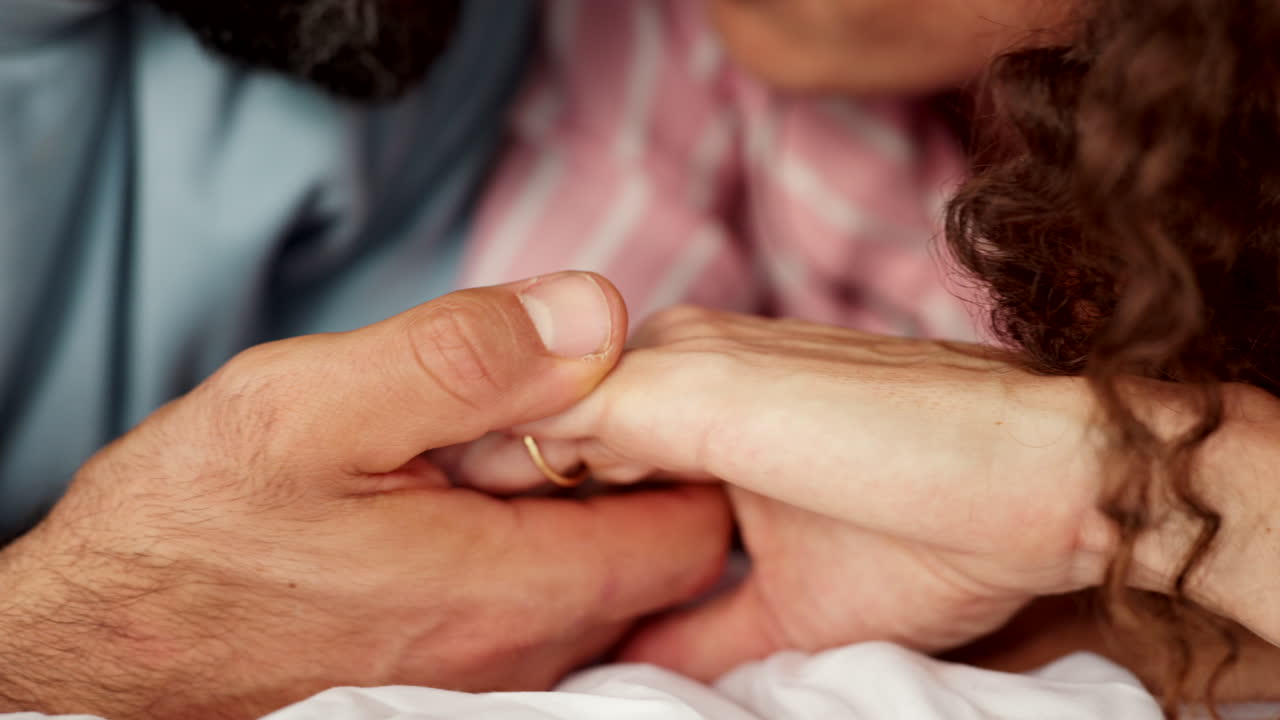Hands, face and love with a couple in bed together