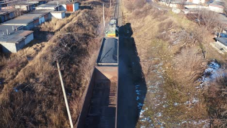 freight train moving in winter. top view on a cargo train on rails. freight transport, railroad and transportation concept. aerial view.