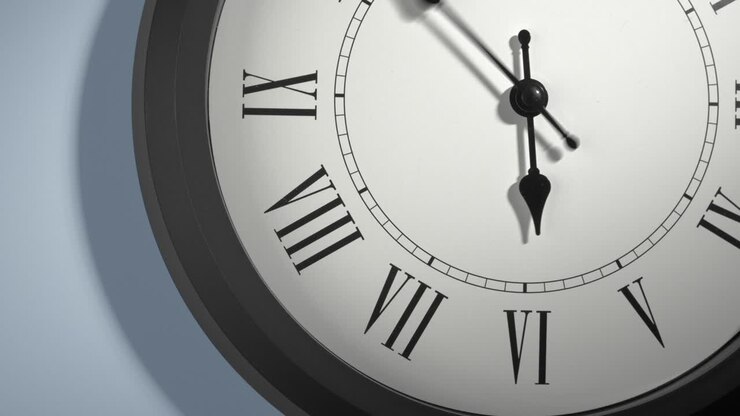Latin Clock Face on Light Blue Wall in Time Lapse