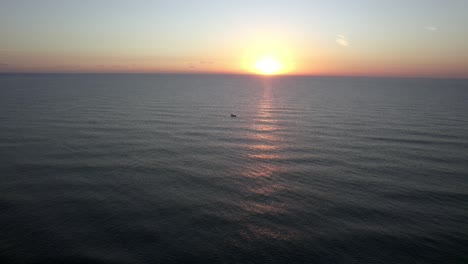 view of the sunrise on the golf of mexico and the boat with a calm sea