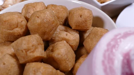 Brown-Fried-Tofu,-Close-Up-with-Pork-Belly-on-Foreground