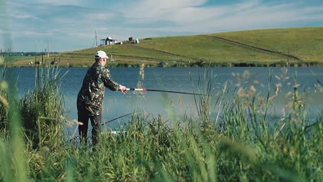 fisherman put a line out with a fishing pole into the lake