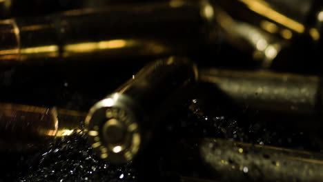 .300 aac blackout cartridge falling on gunpowder pile dust, particles flying out