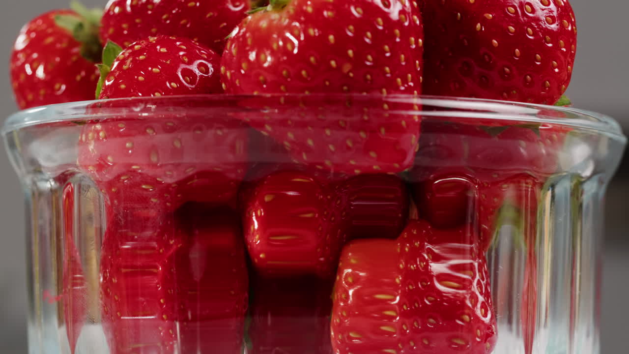 Fresh Red Strawberries Rotating in a Glass Bowl
