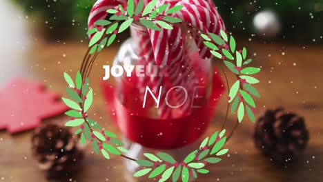 Animation-Von-Joyeux-Noel-Text-über-Zuckerstangen-Und-Dekorationen-Auf-Holzhintergrund