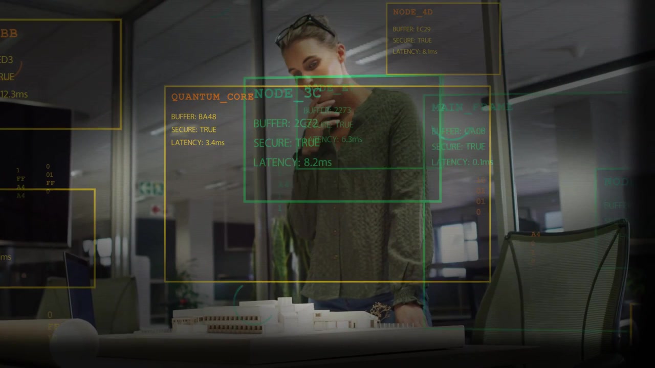 Designer leaning over scale model in office, overlays appearing, updating, analyzing QUANTUM_CORE