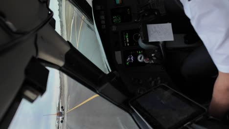 Shoulder-and-arm-of-a-white-pilot-during-the-taxi-behind-another-jet