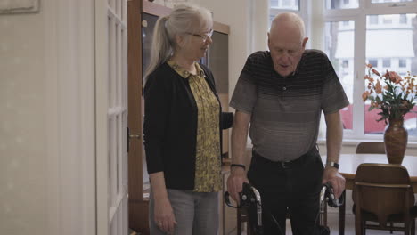 elderly man with walker and caregiver at home