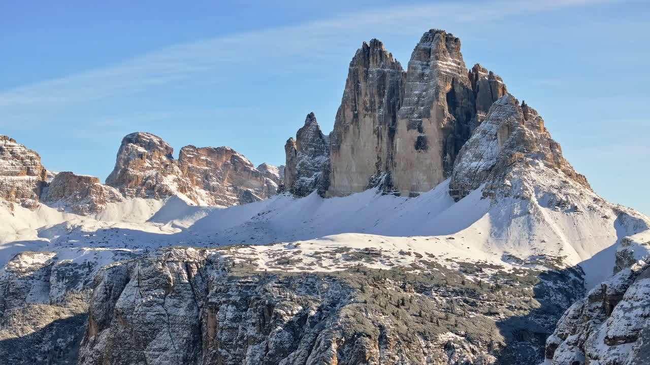 Aerial drone view of the Tre Cime di Lavaredo in the Sexten Dolomites of northeastern Italy with the blue sky on the background