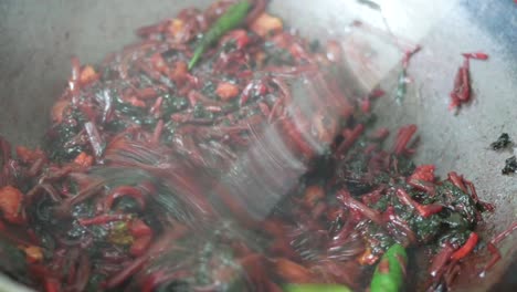 close up of cooking spinach and prawn in a cooking pan