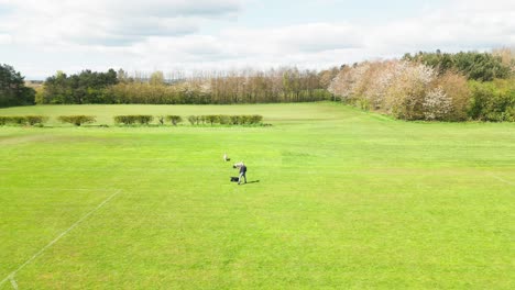 Adult-male,-family-pet-canines,-slow-motion,-sunshine,-grassy-park,-aerial