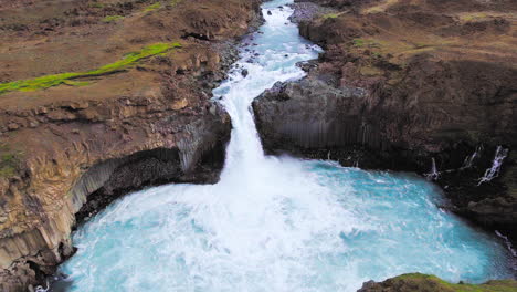 drone aerial view of the aldeyjarfoss waterfall in north iceland.