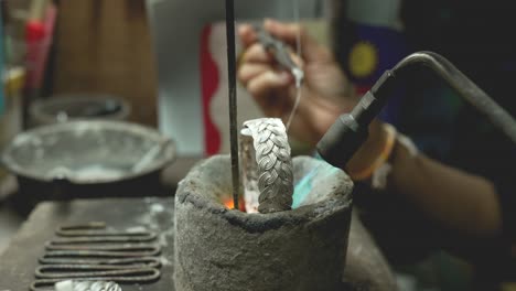 jeweler at work in jewelry. desktop for craft jewelry making with professional tools. close up view of tools. thailand.