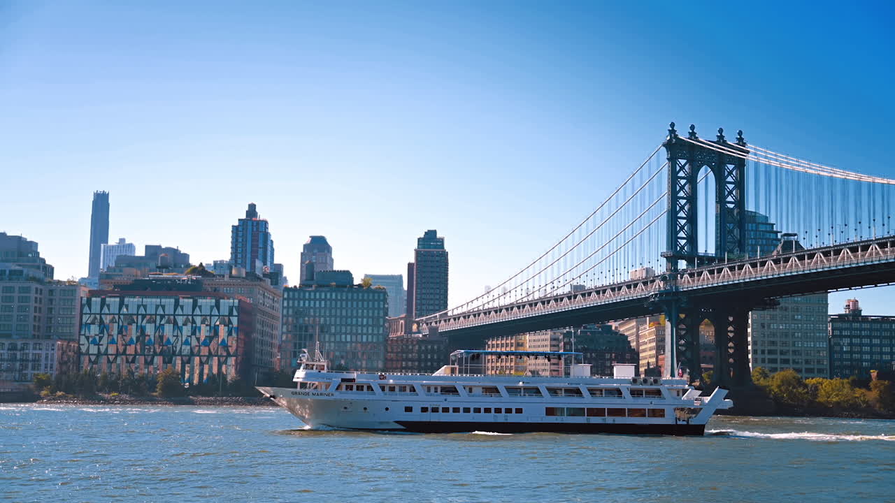 New York, USA, 9 August 2025: Cruise ship on the East River near Manhattan Bridge. Aerial view of a cruise ship moving along the East River near the Manhattan Bridge in New York City