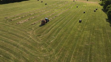 tractor baling hay in the rural fields