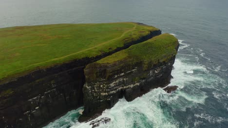 aerial orbit captures the cliffs of loop head and its famous sea stack, county clare