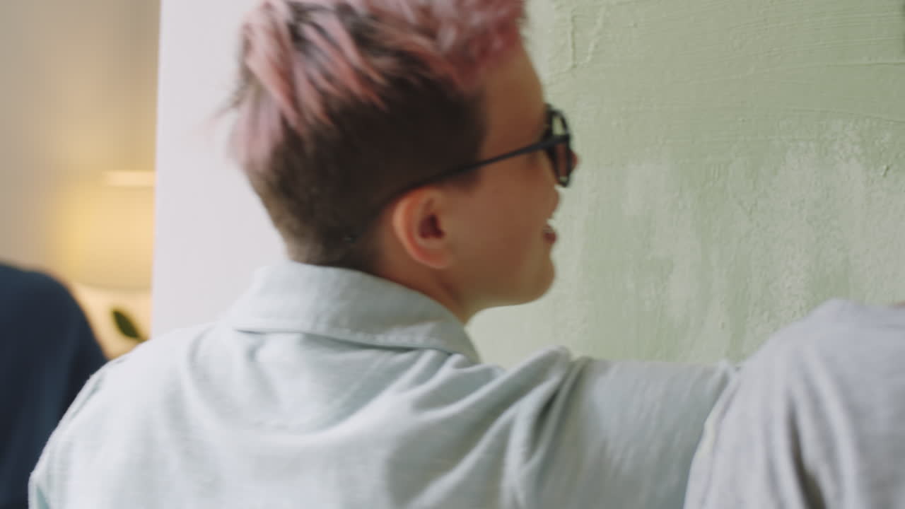 pareja pintando una pared juntos