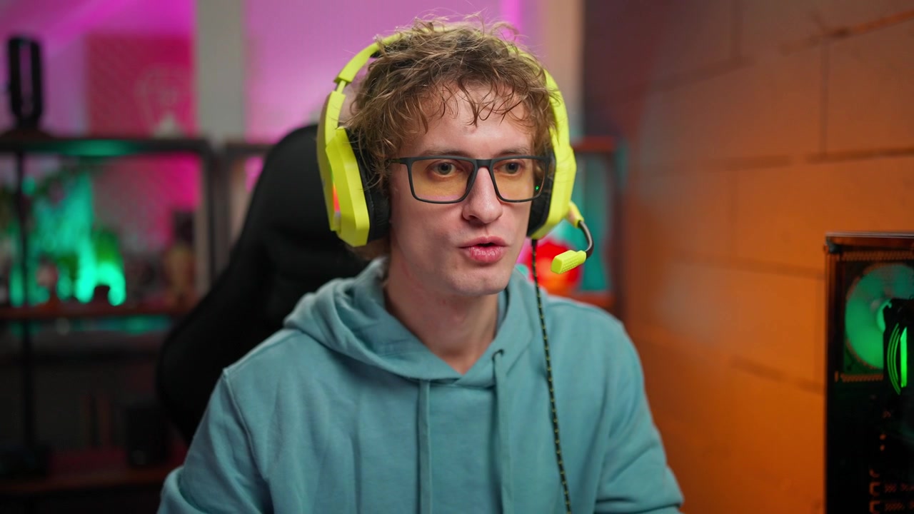 Mladý muž v herních sluchátkách mluví a streamuje