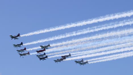 planes perform with colorful smoke in clear sky