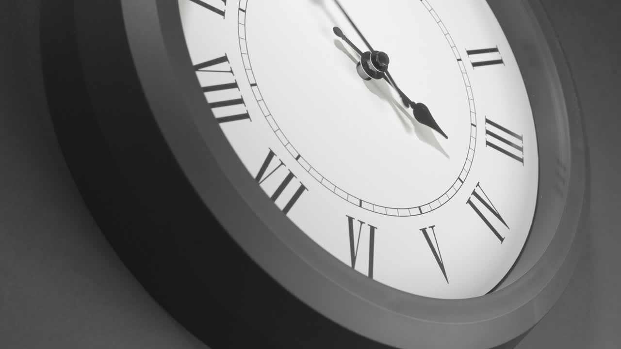 Latin Clock Face in Time Lapse on Dark Grey Wall