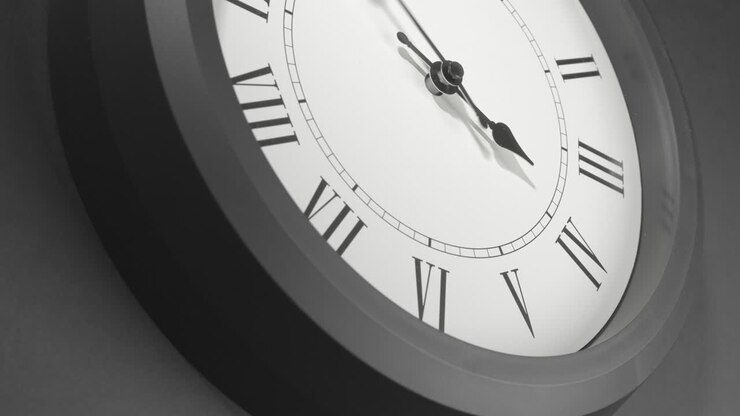 Latin Clock Face in Time Lapse on Dark Grey Wall