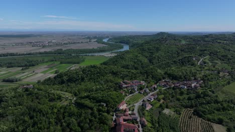 stunning-lush-landscape-of-Po-River-just-outside-of-Gabiano,-Italy,-region-known-for-rare-wines-and-hilltop-traditional-villages,-Gabiano-village-clearly-visible