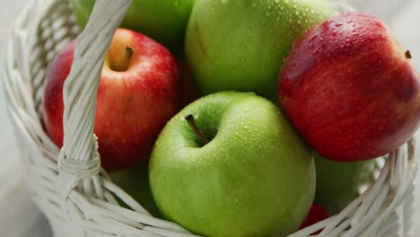 red and green apples in basket