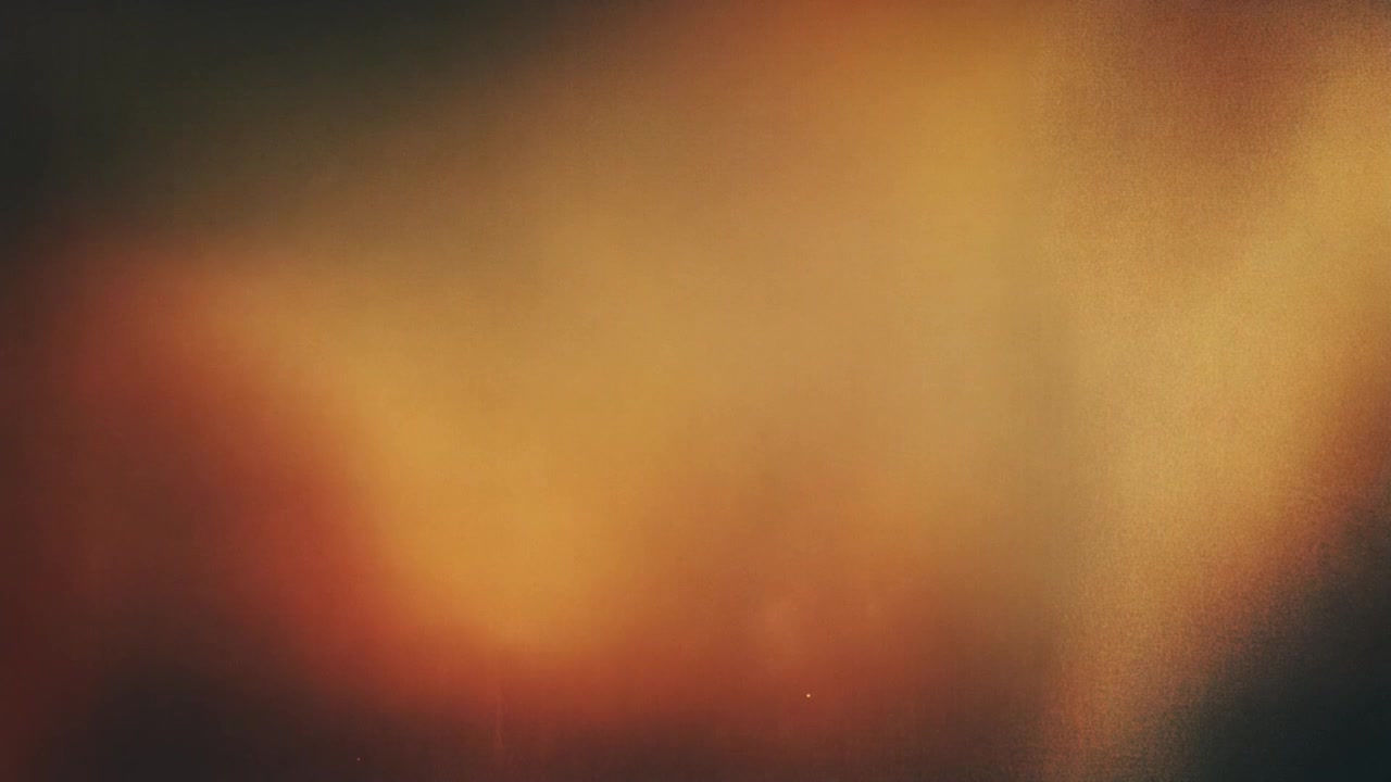 Abstract Background with Warm Golden Light Leaks and Film Grain