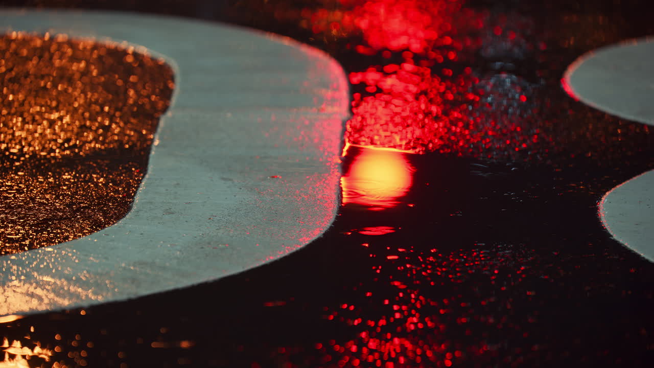 Raindrops hitting the asphalt in the city in the evening. Tokyo, Japan
