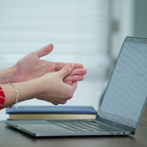 pain in female's palm. woman feeling pain in wrist after typing on laptop. professional trauma.