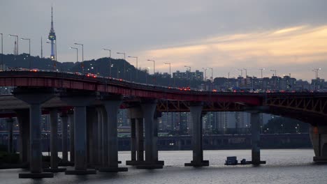 traffic at seongsu bridge over han river in seoul, south korea on a sunset