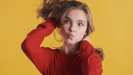 teenage caucasian girl posing and smiling in front of the camera.