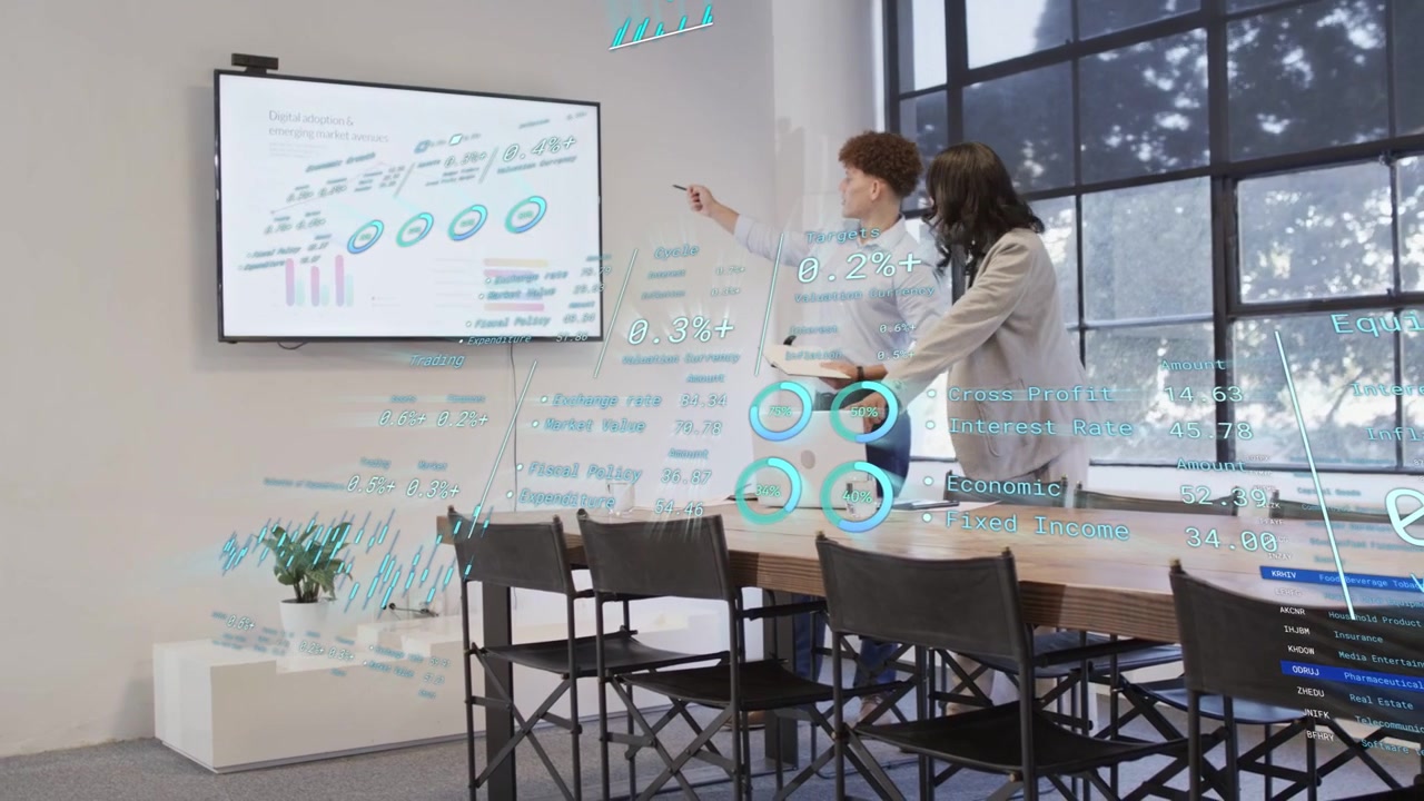 Man tapping tablet showing business holo charts while woman adjusting UI and reviewing data