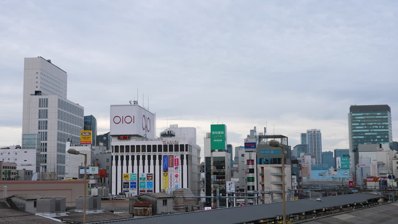 Pan shot of buildings and a shopping street, at a cloudy, autumn day, in Ueno, Tokyo, Japan