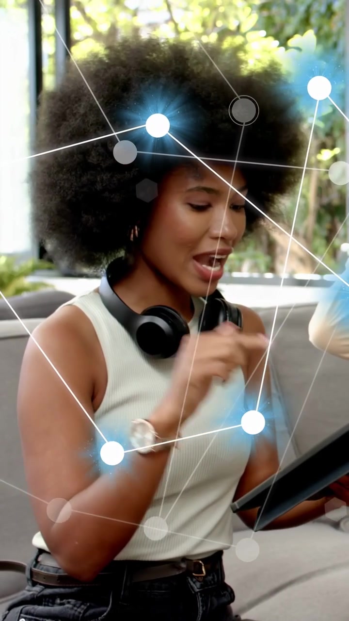 Vertical video: Woman tapping tablet, explaining tech, raising hand and causing network overlay